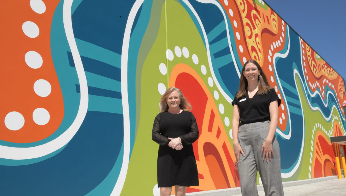 Councillor Laurie Koranski and Woolworths’ Savanah Powell check out Casey Coolwell-Fisher’s giant mural.