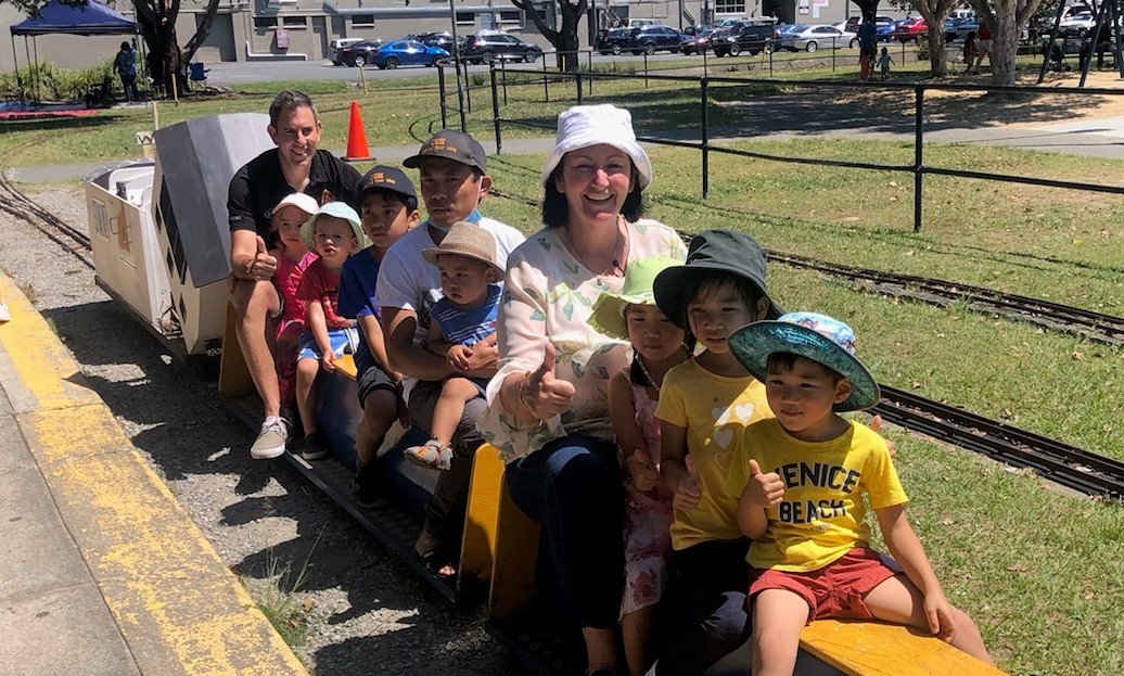 Councillor Teresa Lane and Federal Member for Rankin Jim Chalmers MP with kids enjoying a model train ride.