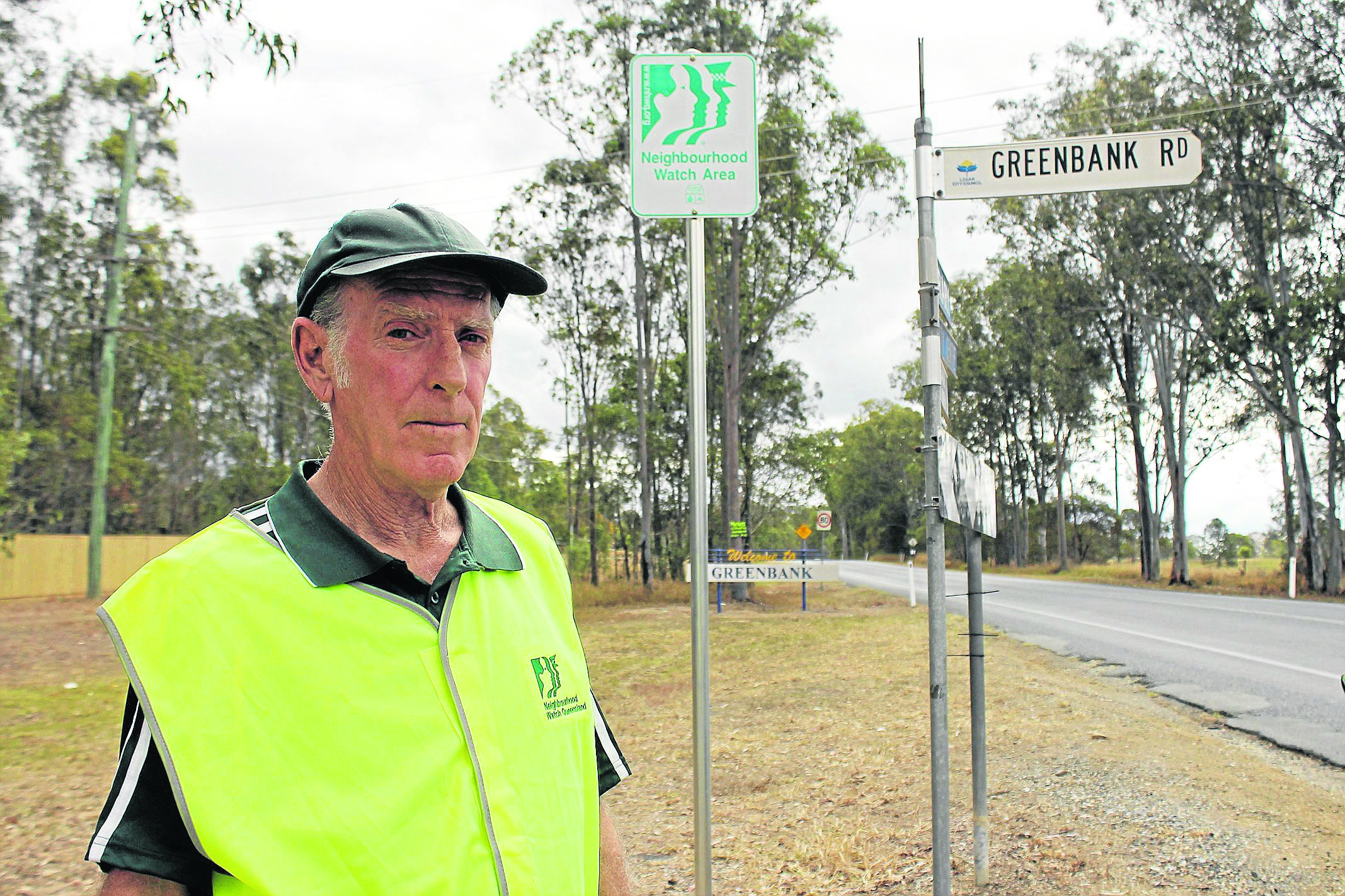 Stan Wells beside a Neighbourhood Watch sign