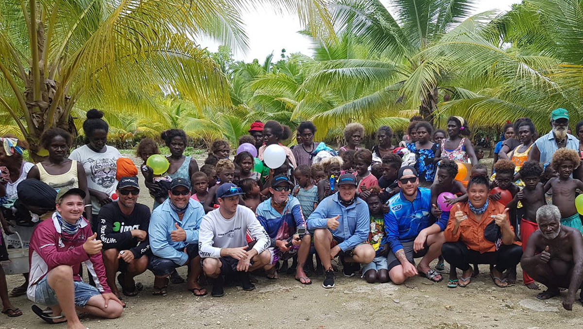 Ivan and his team with the villagers they support in the Solomon Islands.