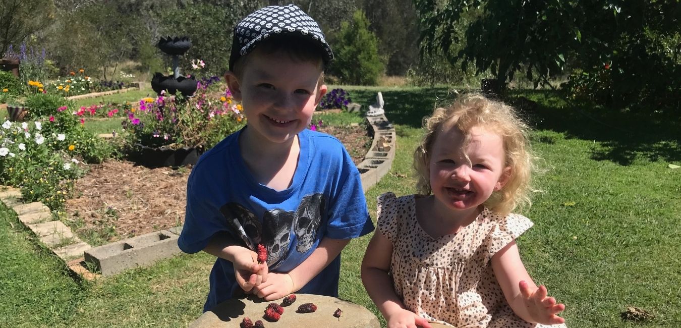 Two little locals sample some of the tasty treats grown at Jimboomba Community Garden