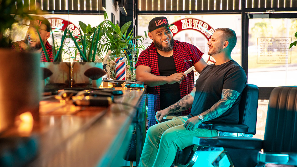 Spasifik Cuts barber Nicky Pati smiling with customer in chair