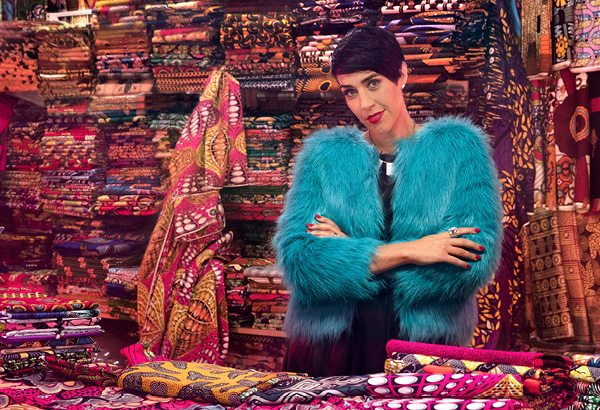Emma posing with colourful fabrics