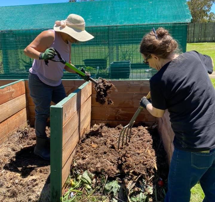 Our Logan | Logan City Council | What's On in Logan - volunteers preparing compost at the raised gardening beds at the Jimbelungare Community Garden.