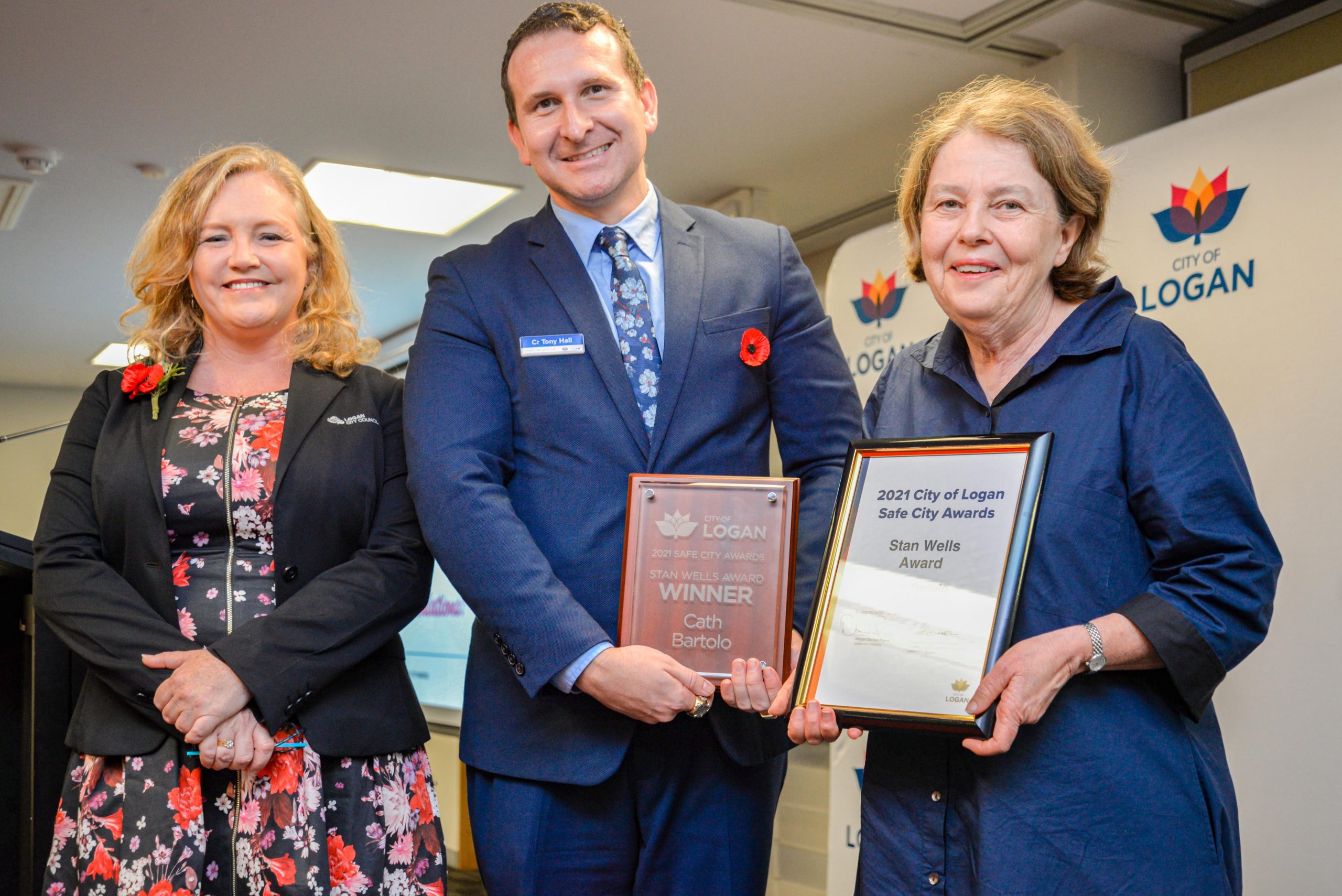 Councillor Laurie Koranski and Councillor Tony Hall with Cath Bartolo and her Stan Wells Award at the Logan Safe City Awards 2021. Councillor Laurie Koranski and Councillor Tony Hall with Cath Bartolo and her Stan Wells Award at the Logan Safe City Awards 2021.