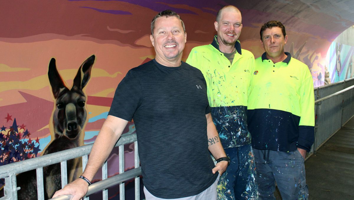 An image of Division 9 Cr Scott Bannan at the Safe Crossing with mural artists Paul Turnbull and Jay Christensen