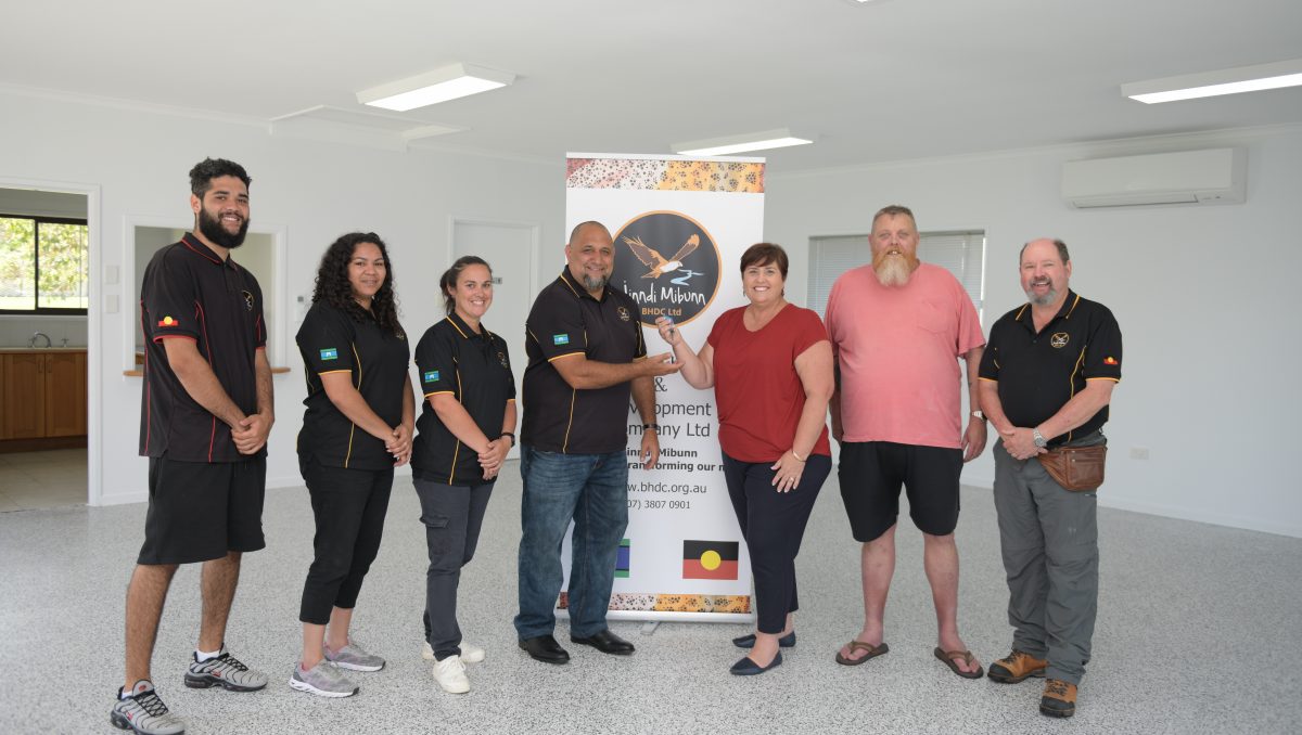 Cr Karen Murphy hands over the keys to renovated 1 Bishop St, Eagleby to BHDC Chief Executive Officer Will Davis. Also pictured are (from left) Zaine Daylight Davis, Maxine Hilt, Amanda Rachow, Uncle Peter Eather and Randall Wardell.