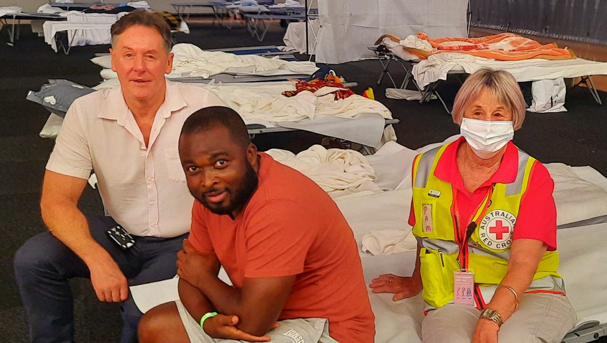 City of Logan Mayor Darren Power with displaced Kingston resident Ernest Senga and a Red Cross worker.