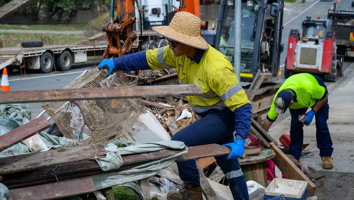 A photograph of kerbside clean-up efforts on a City of Logan street.