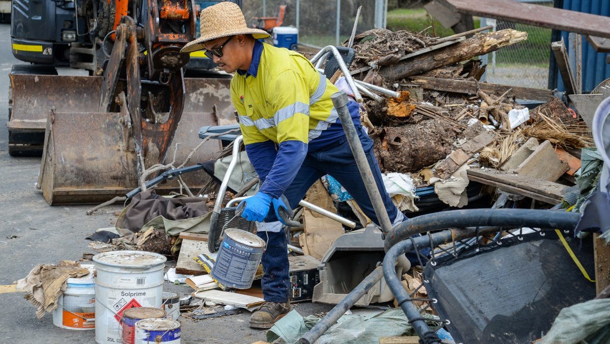 A photograph of kerbside clean-up efforts on a City of Logan street.