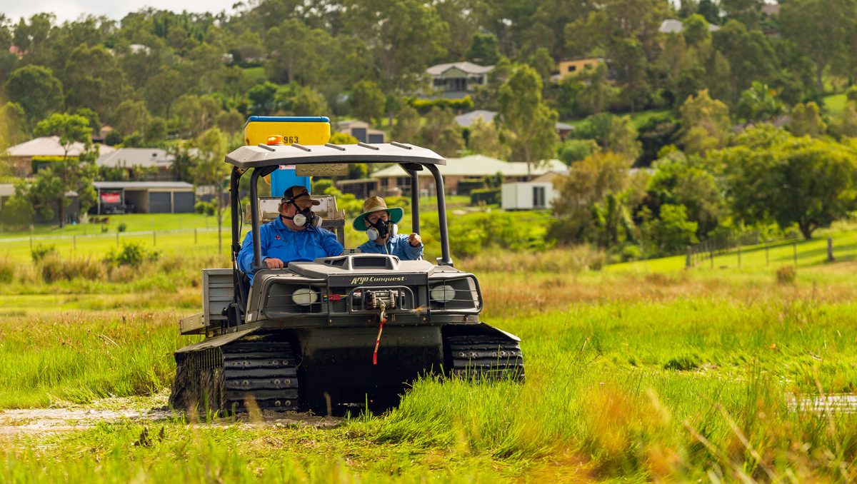 A photograph of mosquito spraying from the back of a buggy in a City of Logan park.