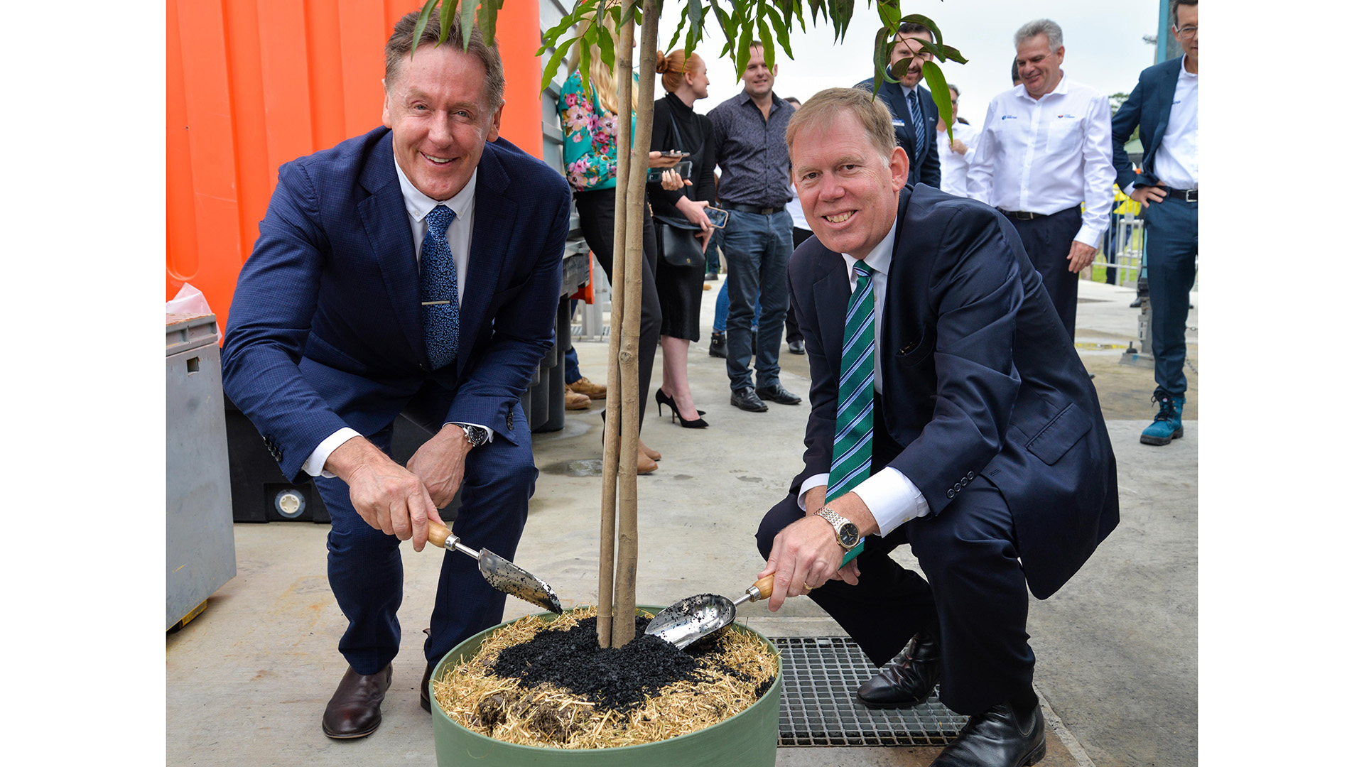 City of Logan Mayor Darren Power and Federal Member for Forde Bert van Manen use the biochar to fertilise a native tree.