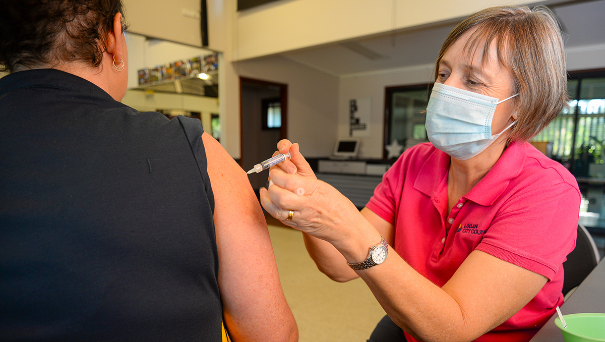 Senior nurse Sue Twible administering, in line with Logan City Council's immunisation plan.