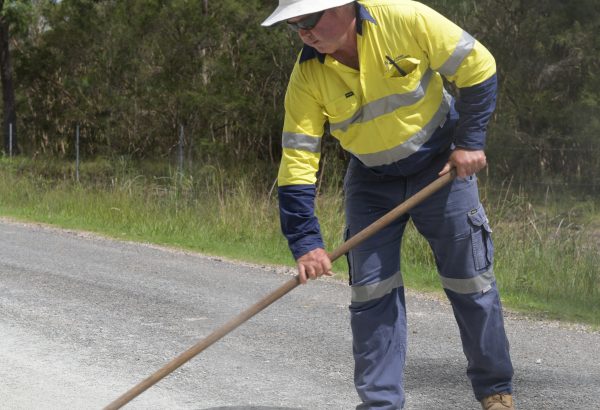 Man shovels bitumen