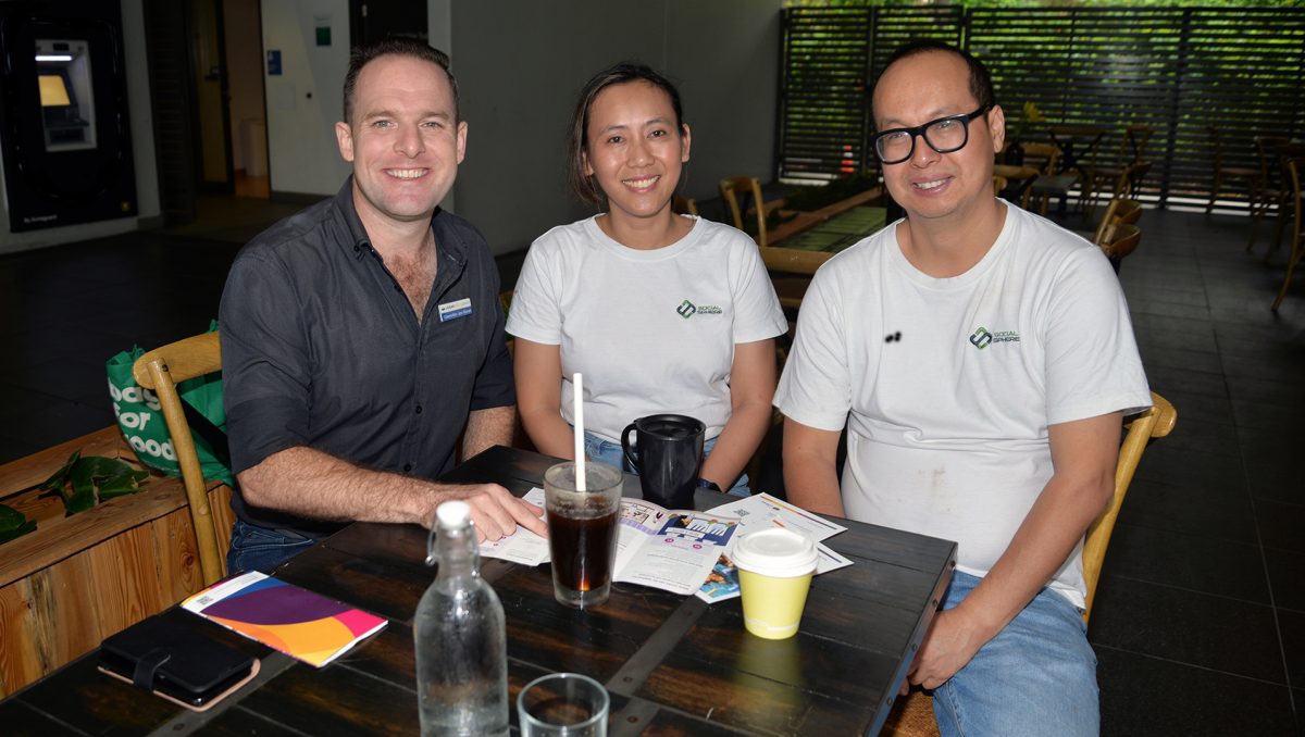 An image of Planning Chair, Councillor Jon Raven, having coffee as he listens to feedback from Berrinba residents Linda and Phuc Nguyen, who operate Social Sphere Café at Marsden.