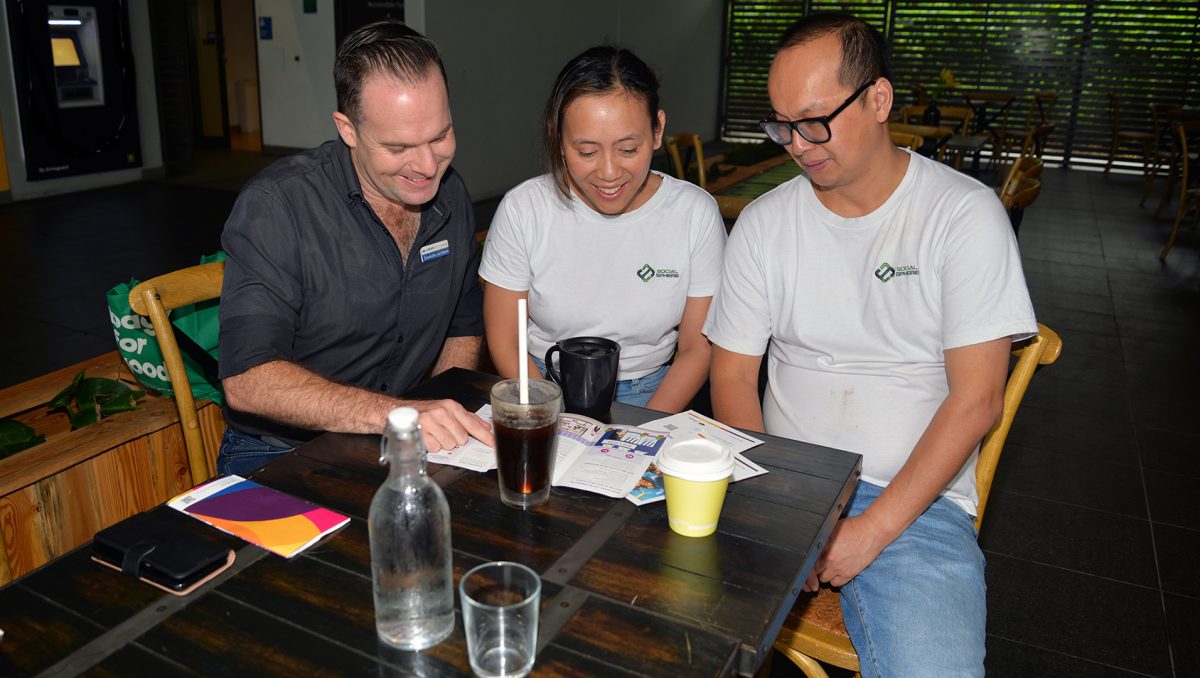 An aimge of Planning Chair, Councillor Jon Raven, having coffee as he listens to feedback from Berrinba residents Linda and Phuc Nguyen, who operate Social Sphere Café at Marsden.