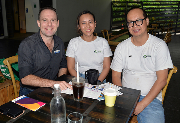 An image of Planning Chair Councillor Jon Raven (left) having coffee as he listens to feedback from Berrinba residents Linda and Phuc Nguyen, who operate Social Sphere Café at Marsden