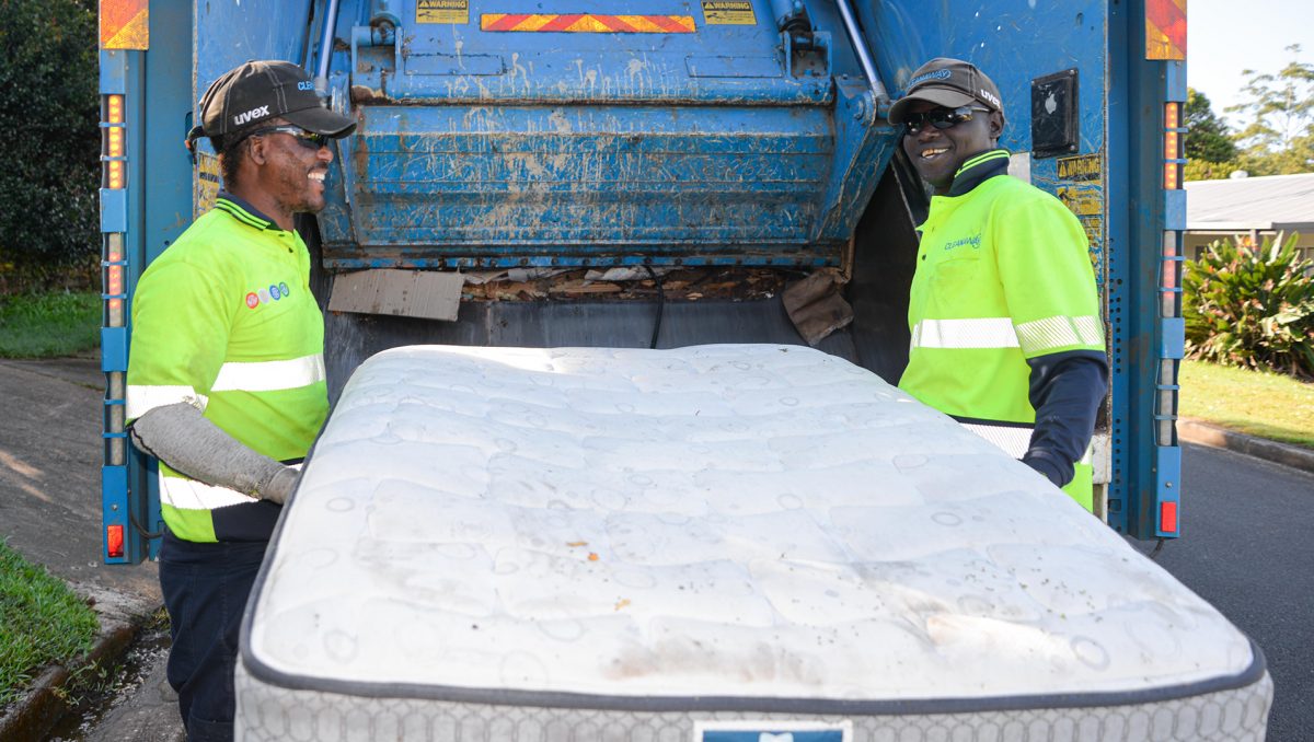 An image of Morris Jonson (left) and Ochan Obali remove a mattress during a kerbside collection in Shailer Park. to demonstrate that Mattresses will be recycled rather than sent to landfill.