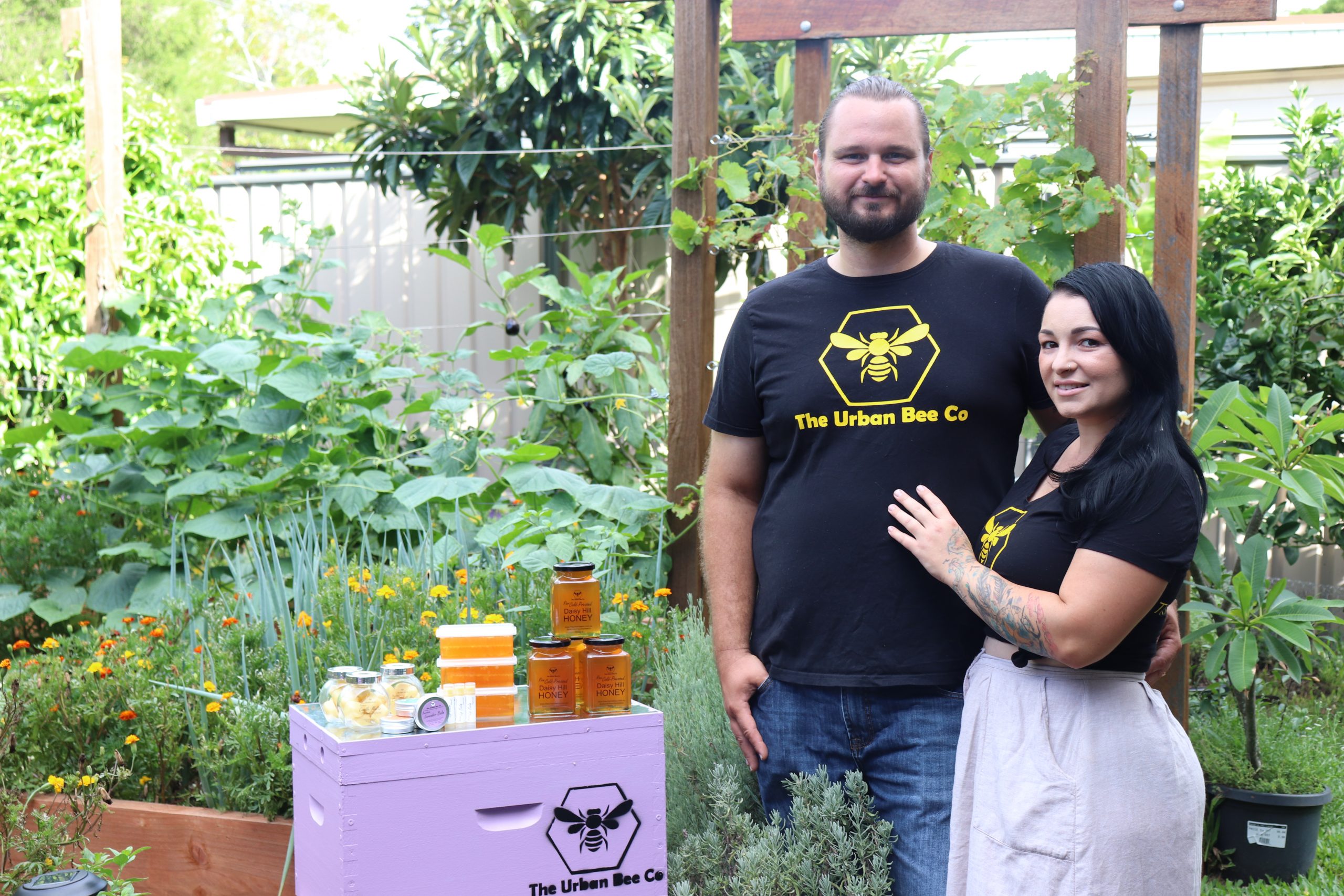 Talis and Stephanie, founders of Urban Bee Co, with some of their hives and honey