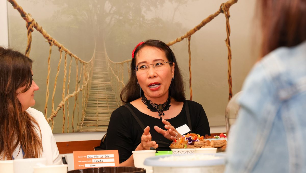 Eagleby resident Marlina Doak, who is of Indonesian heritage, shares a dish of Tahu and Tempe bacem with attendees at a recent Stories from the Kitchen event.