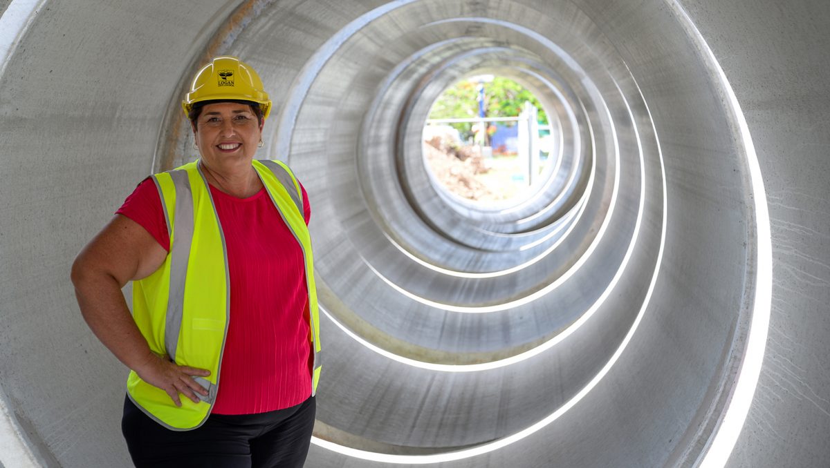 Division 12 Councillor Karen Murphy inspects a stormwater pipe as upgrades take place at Eagleby.