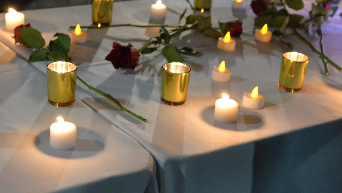Candles adorned tables at last year's domestic violence awareness vigil in the City of Logan.