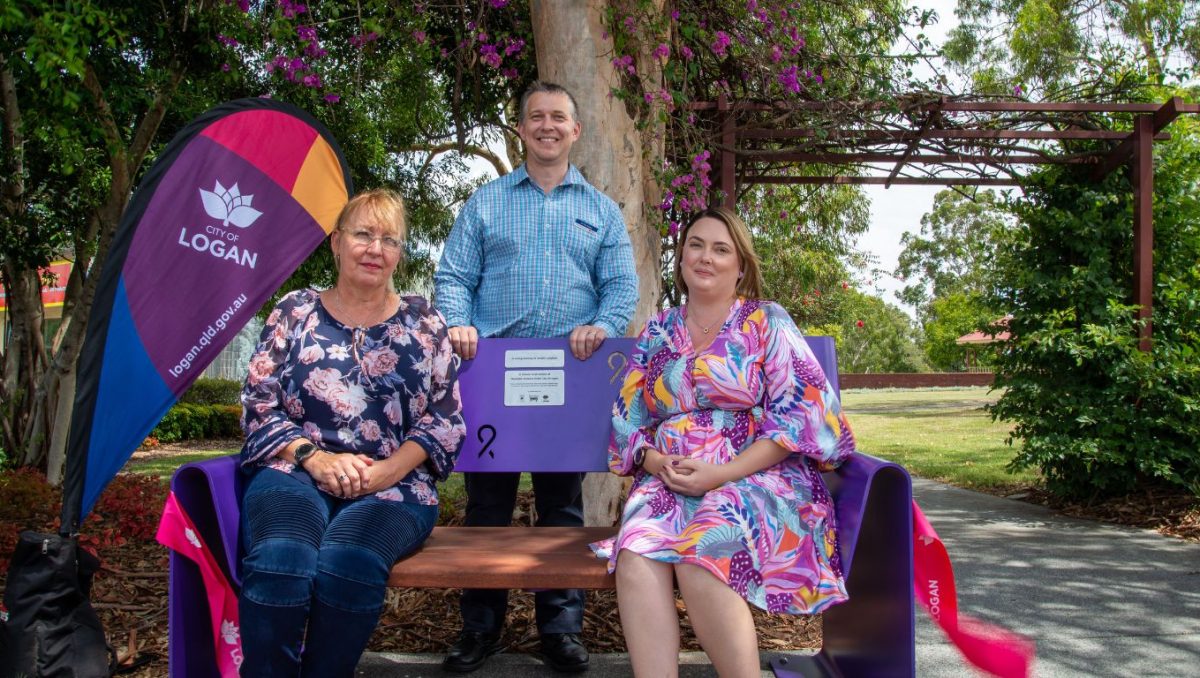 Councillor Tim Frazer unveils the purple bench at Silvertop Park, Hillcrest with Kathy Smith of Defenders for Hope (left) and ambassador Shayne Probert.