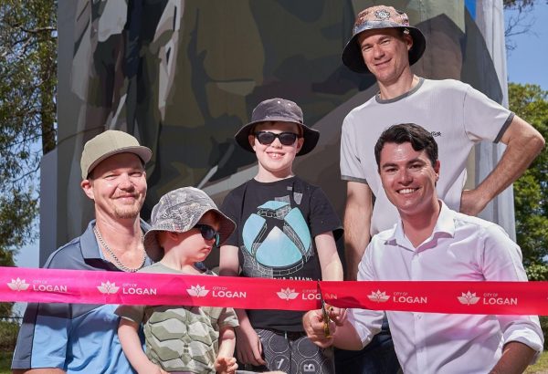 Councillor Jacob Heremaia (front right) joins artists Paul Turnbull, Laing Rahner and the artists’ children in cutting the ribbon for the new mural on the Park Ridge water tower.