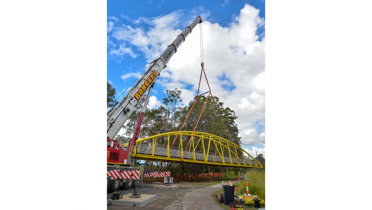 A crane begins its work at the new Slacks Creek bridge site.