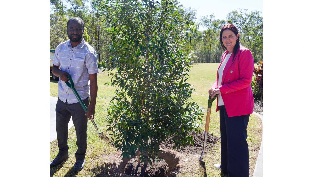 Hadrian Obi and Cr Natalie Willcocks planting a tree in Spring Mountain Lagoon Park.