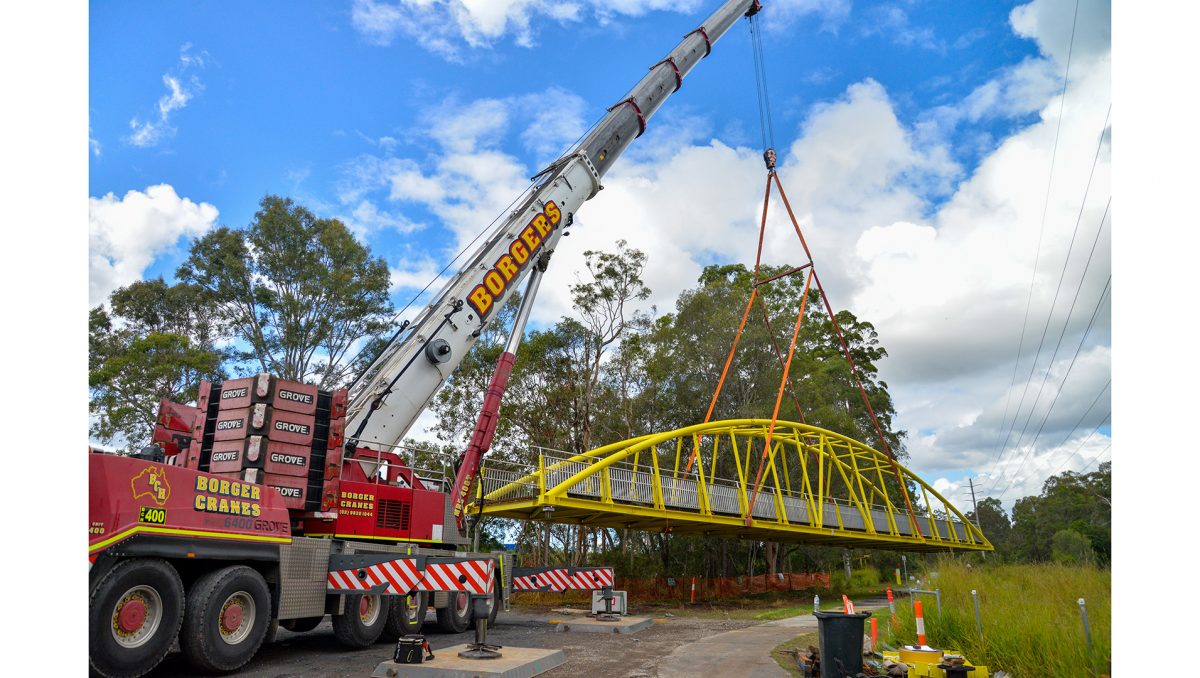 A new bridge at Slacks Creek is craned into place.