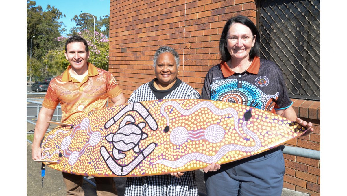 Logan City Councillors Tony Hall and Teresa Lane (far right) and Logan District Aboriginal & Torres Strait Islander Corporation for Elders representative Aunty Leoni Lippitt (centre) with one of the prizes to be raffled at the Logan NAIDOC Family Fun Day.