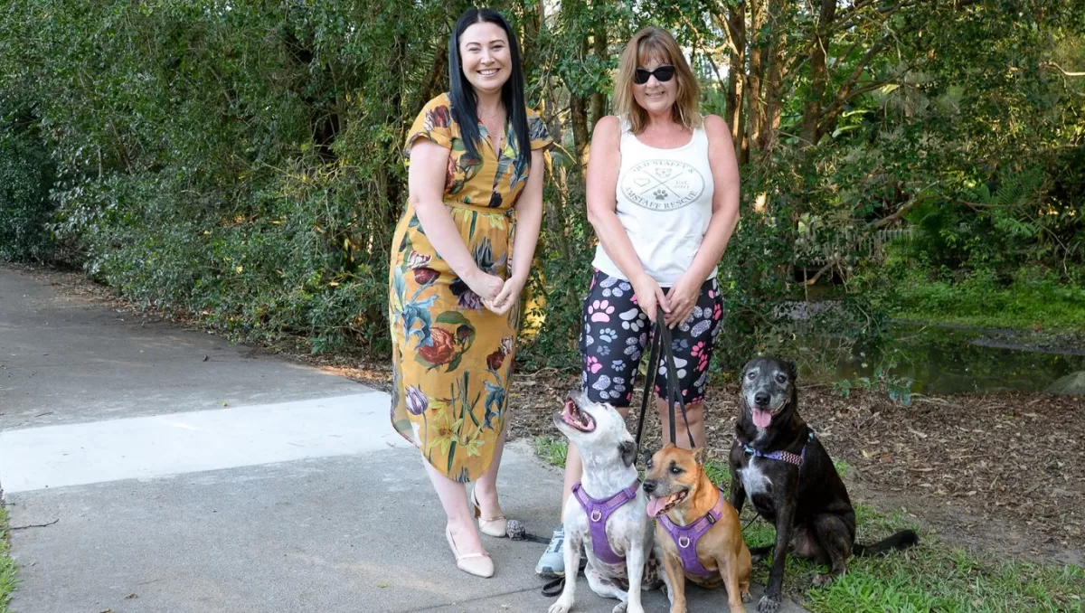Councillor Mindy Russell (left) with Shailer Park resident Leah King and her dogs Indie, Koda and Mister on a recently repaired footpath.