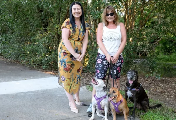 Councillor Mindy Russell (left) with Shailer Park resident Leah King and her dogs Indie, Koda and Mister on a recently repaired footpath.
