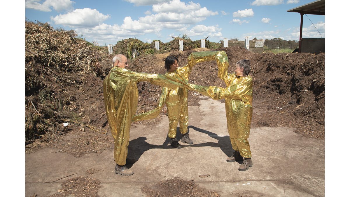 Eugenia Lim has captured this image of three people in gold mylar costumes connected to each other for the Conflated exhibition.