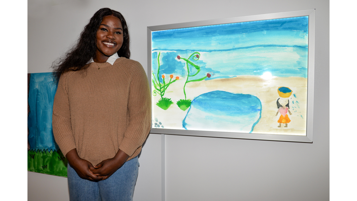 Boronia Heights resident Katty Okeny with the artwork she produced 10 years ago as an 11-year-old Woodridge State School student.