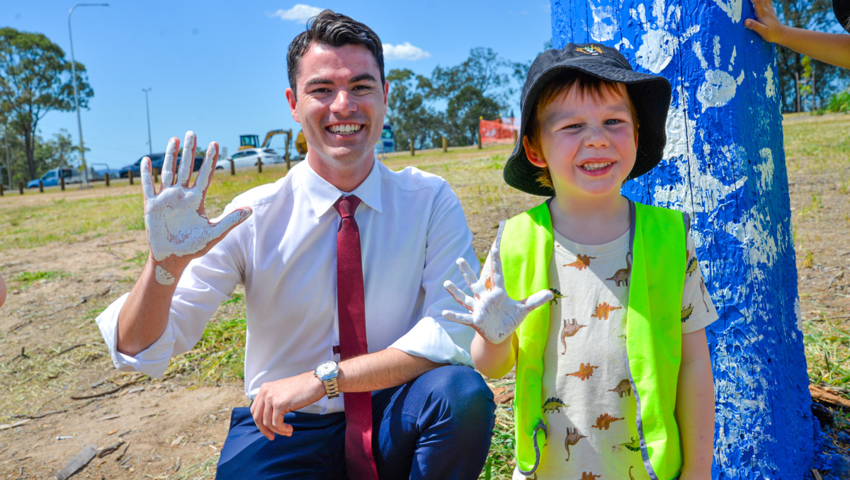 Division 8 Councillor Jacob Heremaia and Logan Reserve youngster Isaac McPhail, 4, add their handprints to the new blue tree in Logan Reserve.
