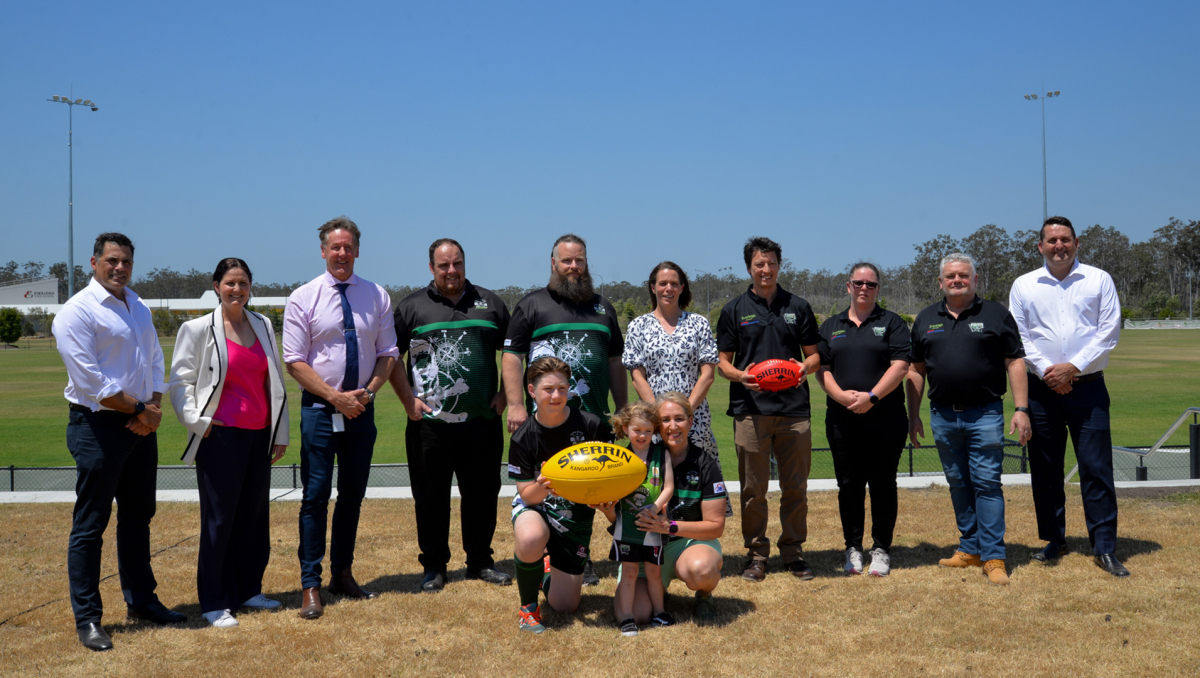 Mayor Darren Power with (from left) Mirvac General Manager Residential Queensland Warwick Bible, Cr Natalie Willcocks, Park Ridge Pirates Junior Club members Chris Luxford, and Matthew McLuckie, Head of AFL Queensland Trisha Squires, Park Ridge Pirates Seniors Club members Luke Png, Bek Machielsen, and Terry Carter, and (front) Park Ridge Pirates Junior Club members Archer McLuckie, Hendrix Batty and Dana Bell.