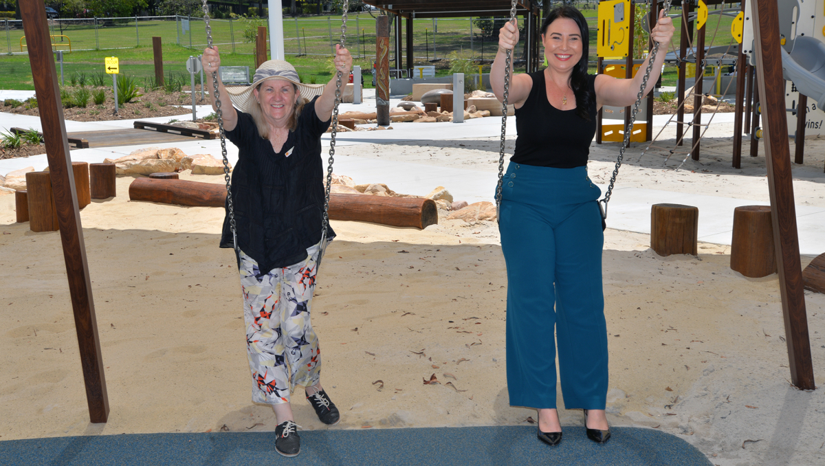 An image of Cr Mindy Russell and Go Duckling's Kym Kukulies on the new swings in Mabel Park.
