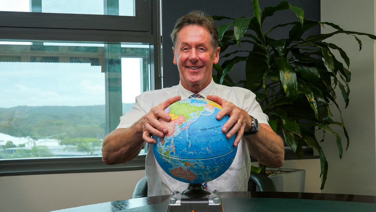 City of Logan Mayor Darren Power with his hands on a globe to demonstrate he is ready to take a global view on quality-of-life issues.