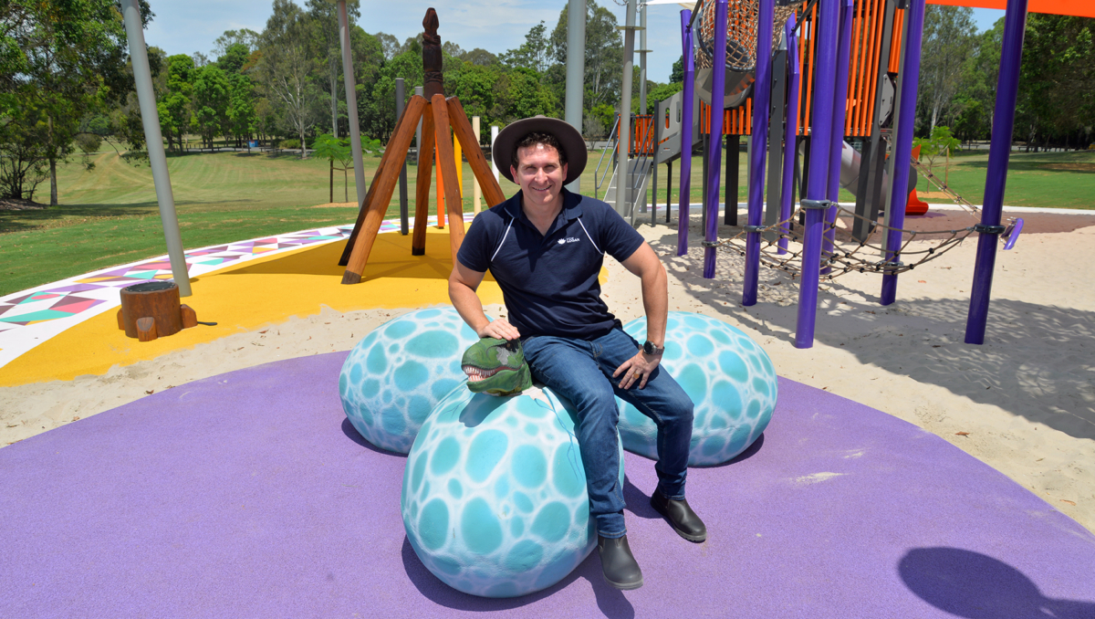 An image of Lifestyle Chair and Division 6 Councillor Tony Hall among the 'dinosaur eggs' at the new playground in Riverdale Park at Meadowbrook.