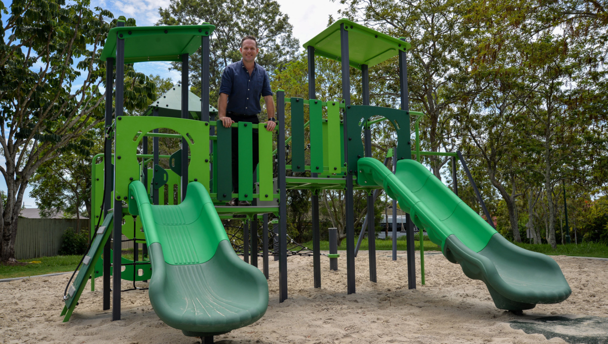 An image of Division 5 Councillor Jon Raven standing on the new play equipment in Lansdown Park in Waterford West.