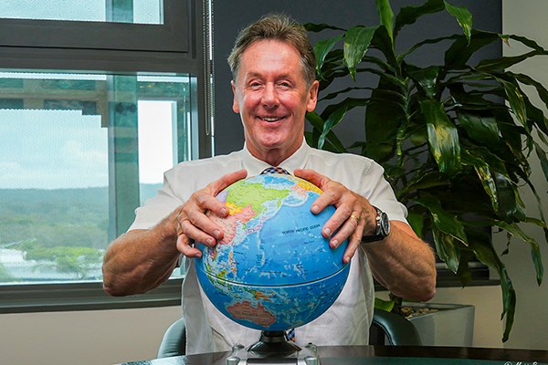 ity of Logan Mayor Darren Power with his hands on a globe to demonstrate he is ready to take a global view on quality-of-life issues.