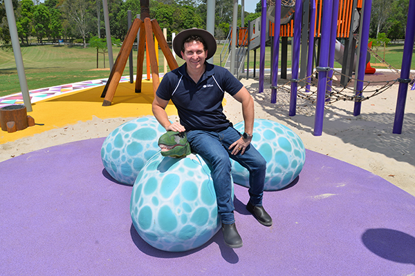 An image of Division 6 Councillor Tony Hall with the 'dinosaur eggs' in the new Riverdale Park playground.