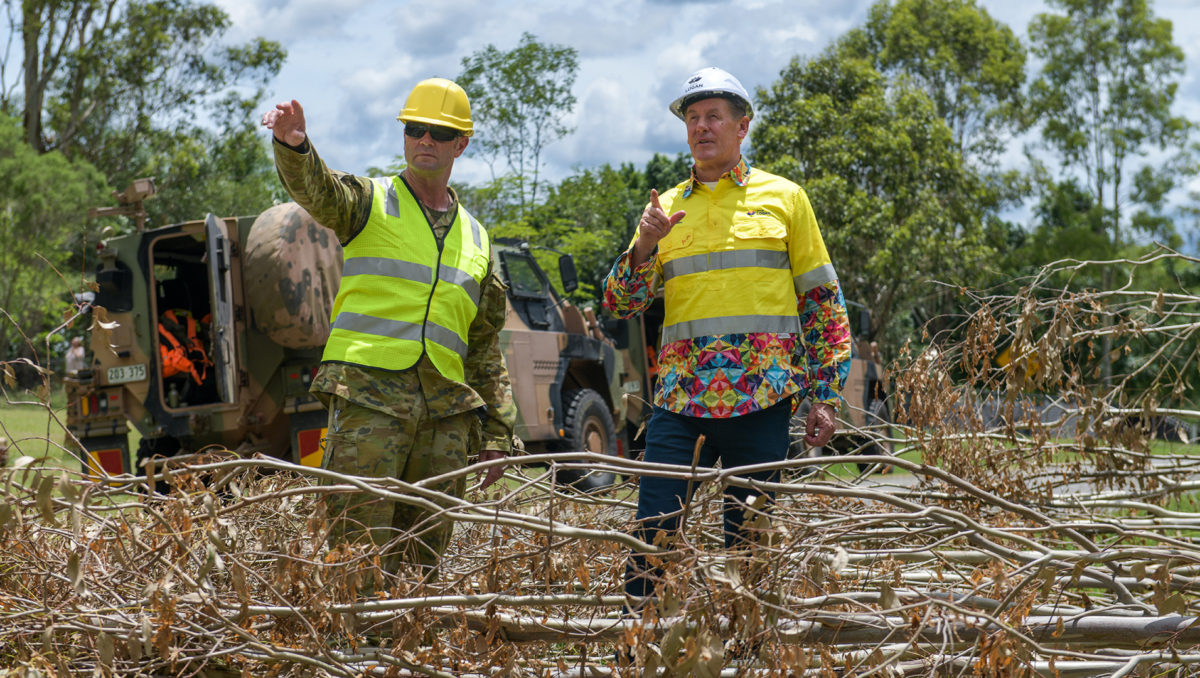 An image of Mayor Darren Power (right) and ADF Sergeant Jason Hatcher, whose Alpha Team were on storm clean-up in the Logan suburb of Cedar Grove today.