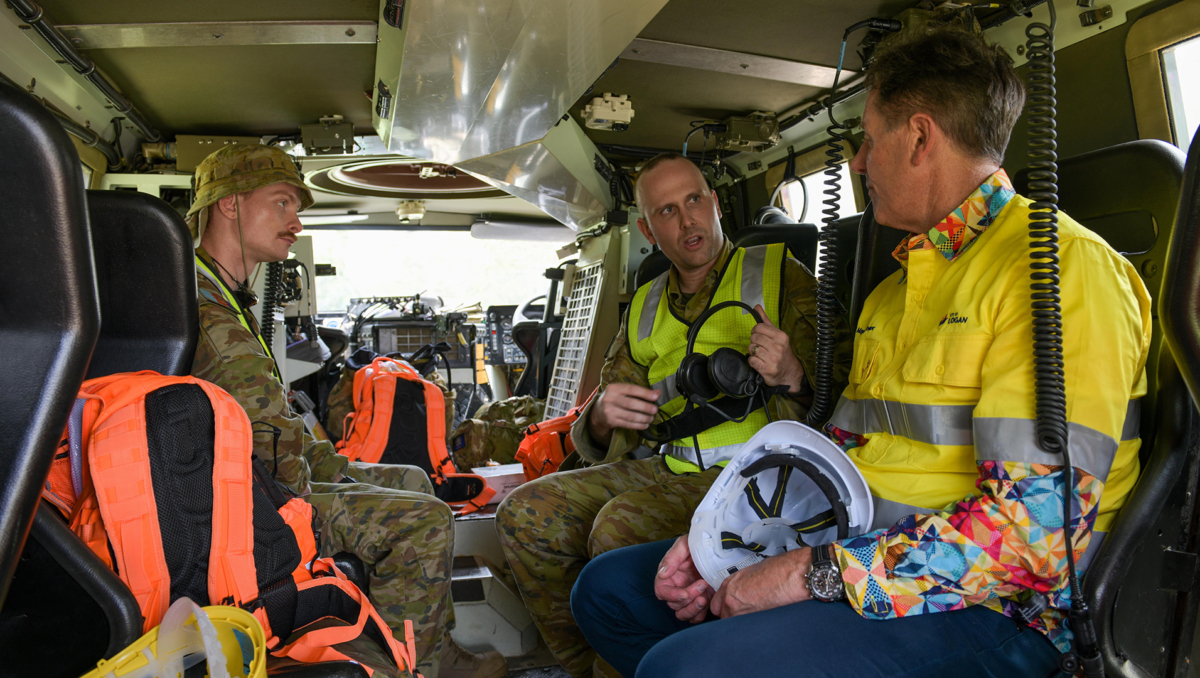 An image of Mayor Darren Power discussings the storm recovery effort with LCPL Matthew Haynes and CPL Oliver James
