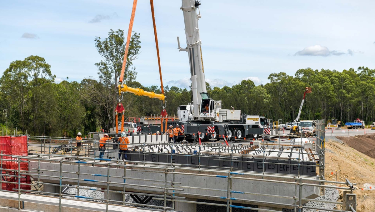 Bridge girders are lifted into place by crane at Munruben’s Norris Creek.