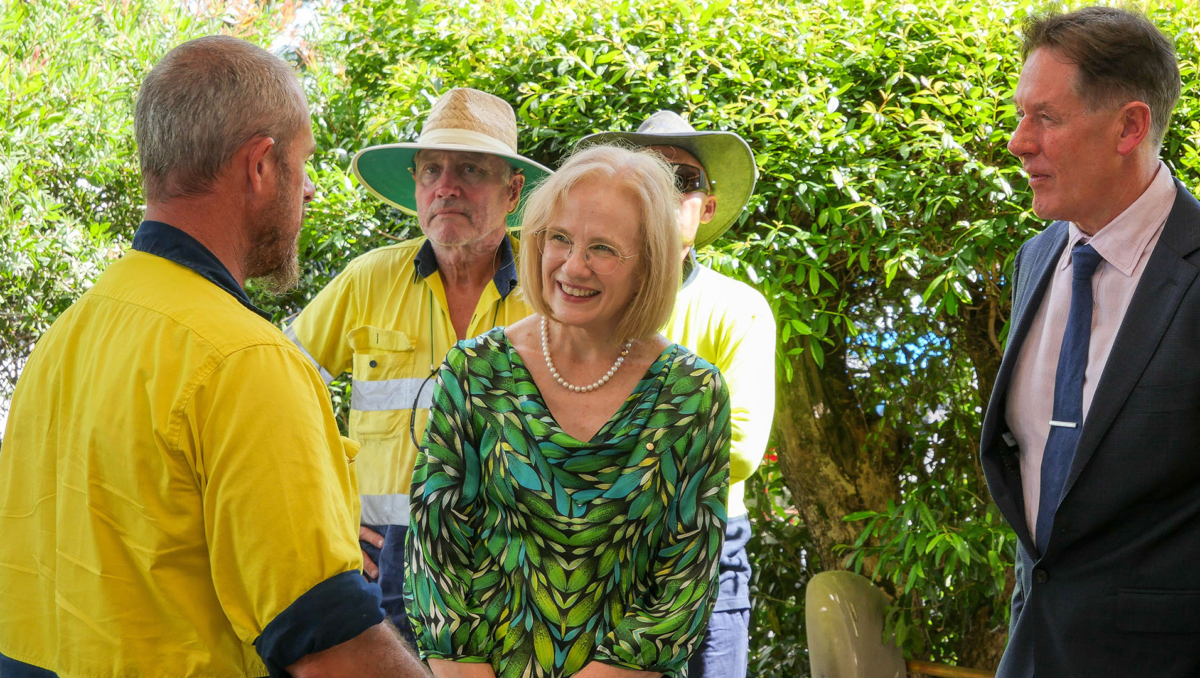 Her Excellency, the Honourable Doctor Jeannette Young AC PSM, Governor of Queensland, speaks with Chris Dittmer as David Stadhams and Mayor Darren Power look on.