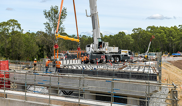 Bridge girders are lifted into place by crane at Munruben’s Norris Creek.