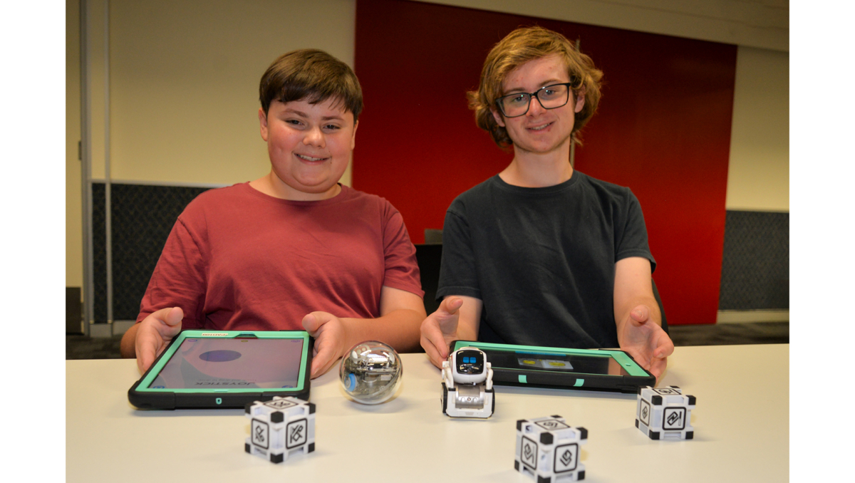 Samuel (left) and William Burgess with some of the robots which will be part of Logan Libraries school holiday workshops.